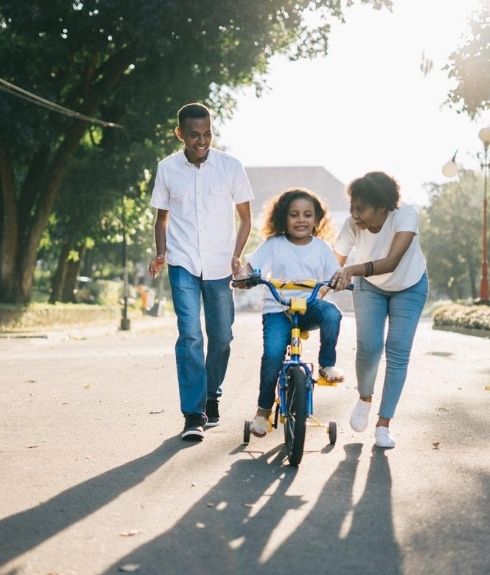 hapy african american family riding bike