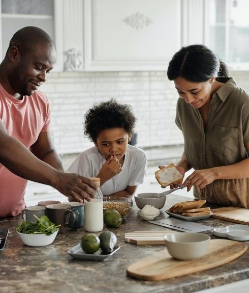 mixed race family making breakfast