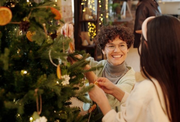 two women decorating Christmas tree