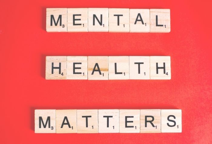 Scrabble letters spell out "Mental Health Matters" on a red background