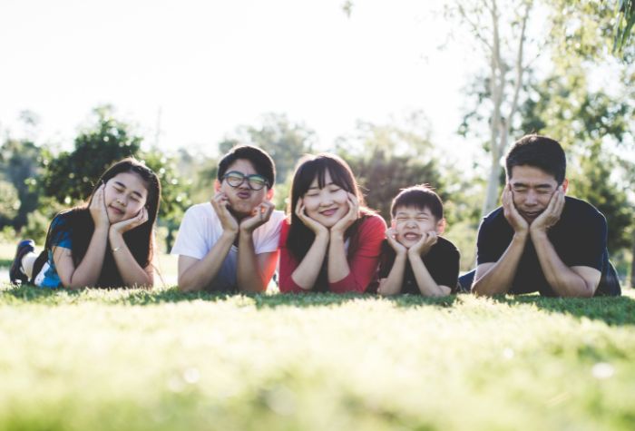 happy Asian family outside together smiling