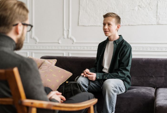 therapist and young client sitting across from one another