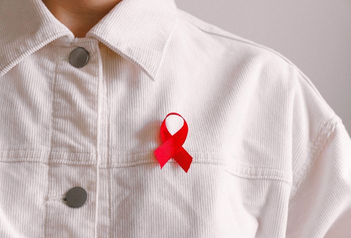 man wearing red ribbon showing awareness for alcohol abuse and dependence