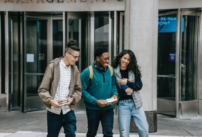 Multicultural teens young adults walking and laughing together